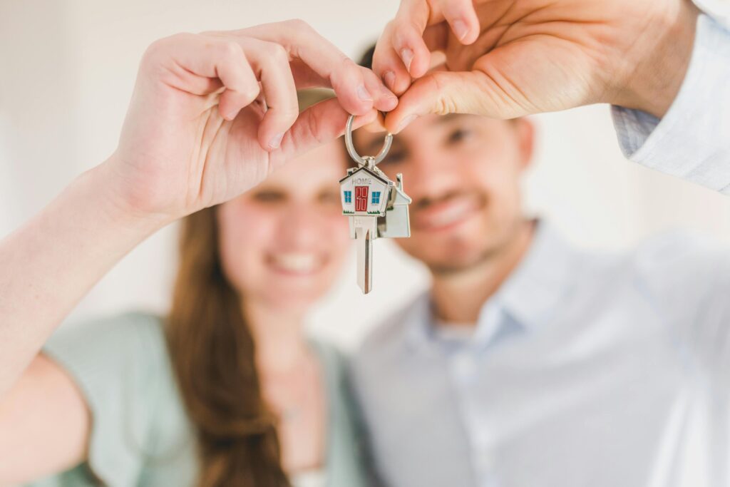 Man and women holding their keys up together | Residential Rent Prices | Bowen Property Management